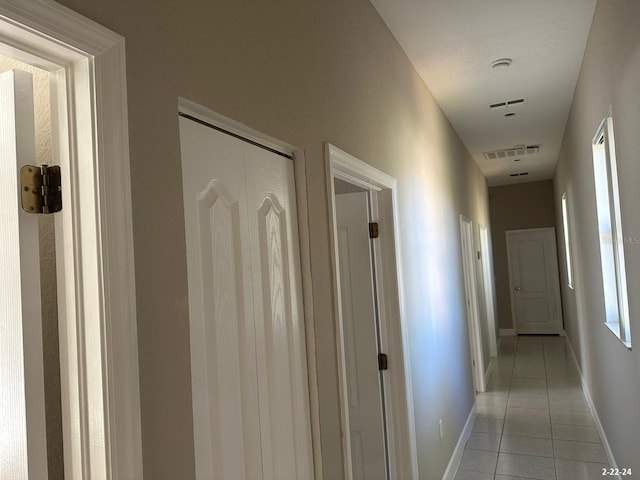 hallway featuring light tile patterned floors