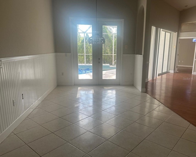 tiled empty room with french doors