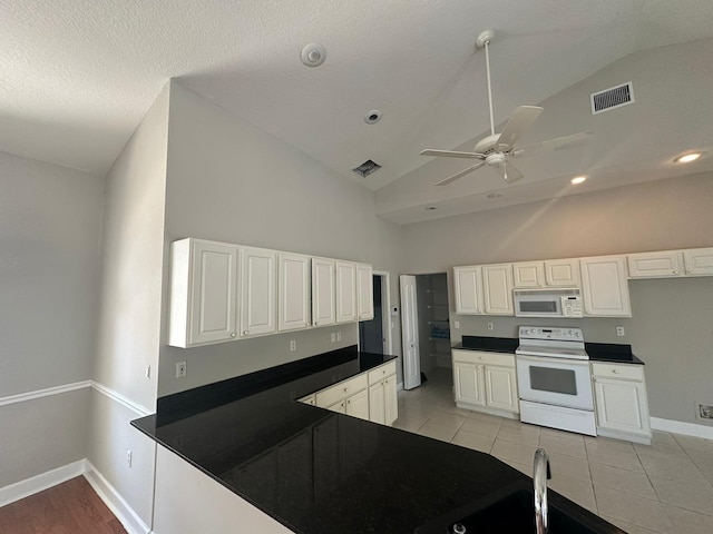 kitchen featuring ceiling fan, light tile patterned flooring, white appliances, white cabinetry, and high vaulted ceiling