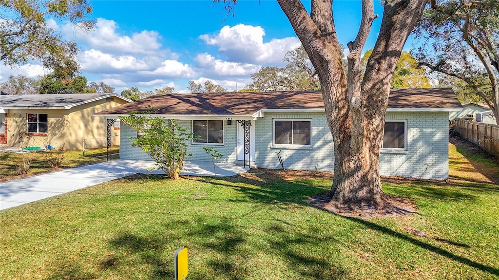 ranch-style house with a front lawn