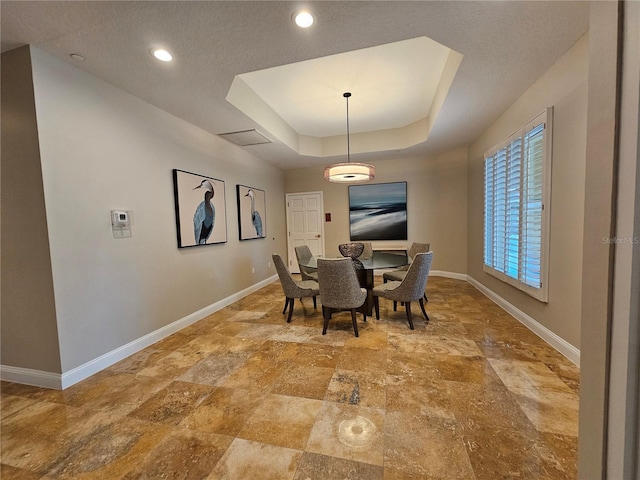 dining space with a tray ceiling