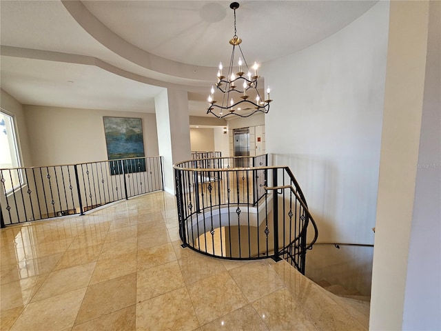 staircase featuring a notable chandelier