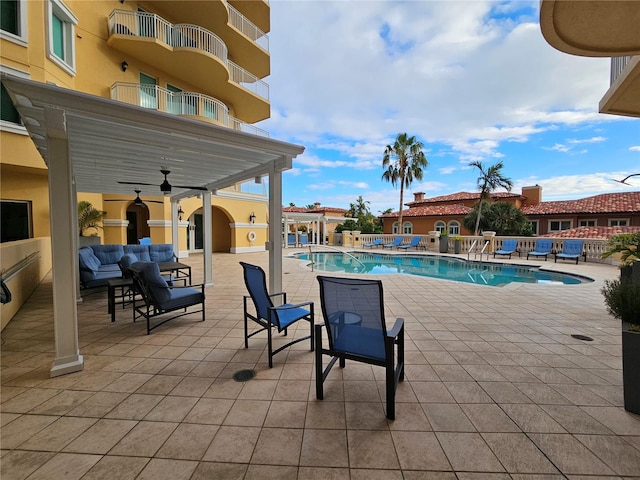 view of pool featuring ceiling fan, outdoor lounge area, and a patio