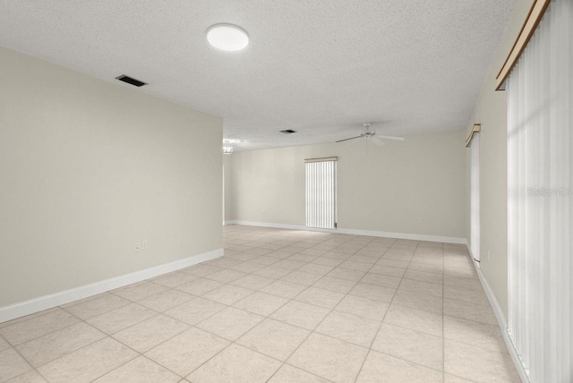 empty room featuring ceiling fan and a textured ceiling