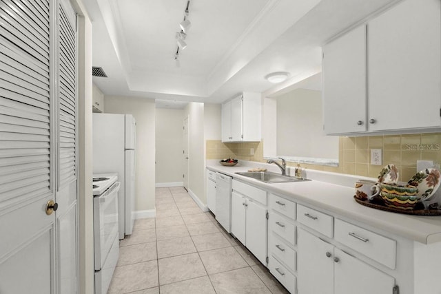 kitchen featuring sink, white appliances, light tile patterned floors, white cabinetry, and a tray ceiling