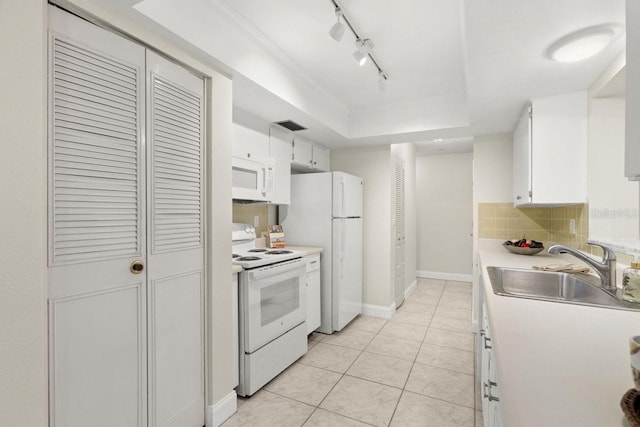 kitchen featuring light tile patterned flooring, sink, backsplash, white cabinets, and white appliances