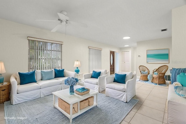 living room featuring ceiling fan and light tile patterned flooring