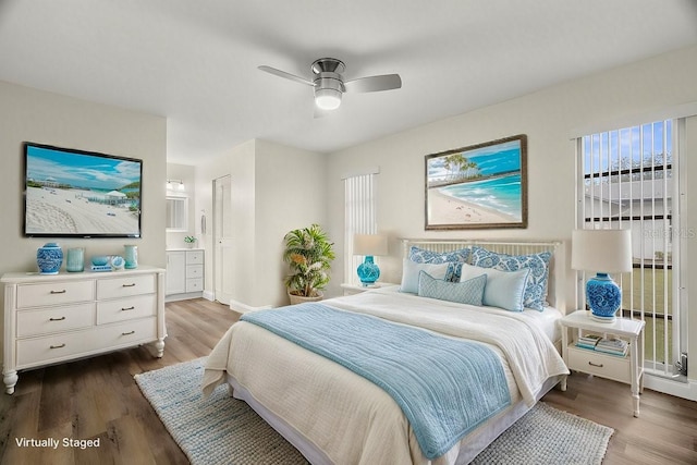 bedroom with connected bathroom, hardwood / wood-style flooring, and ceiling fan