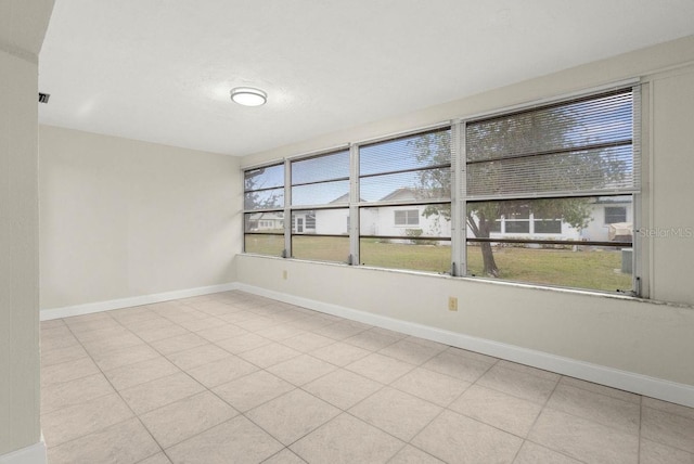 unfurnished room featuring plenty of natural light