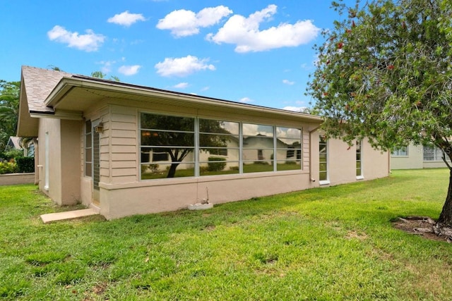 back of property featuring a lawn