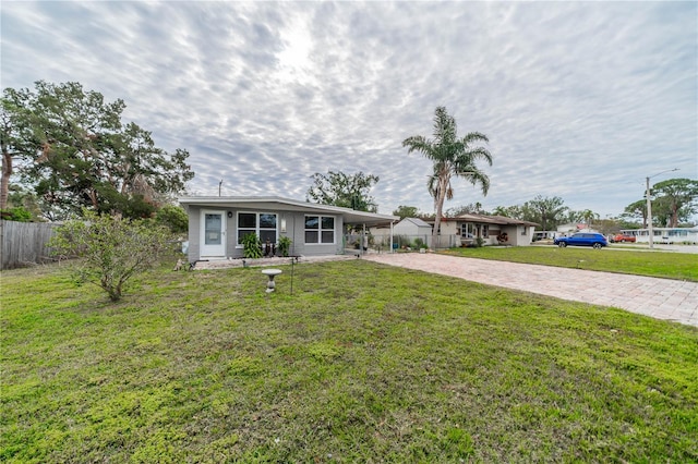 single story home with a front yard and a carport