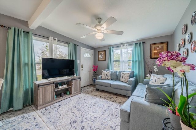 living room with ceiling fan and beamed ceiling