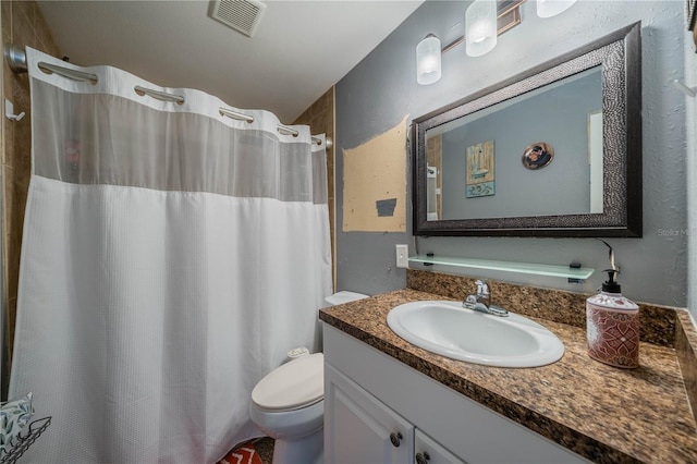 bathroom with toilet and vanity