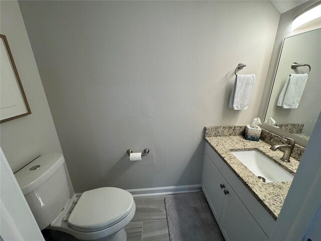 bathroom with toilet and vanity