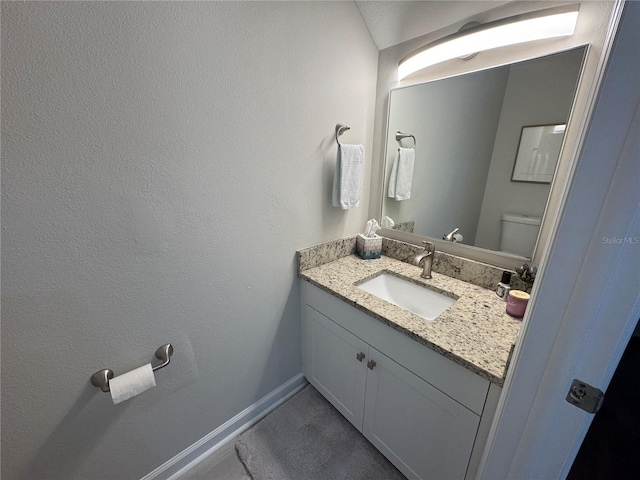 bathroom featuring toilet and vanity