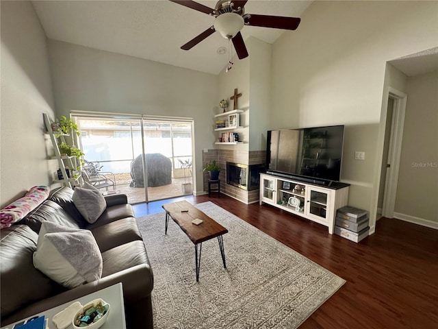 living room featuring ceiling fan, dark wood-type flooring, and high vaulted ceiling