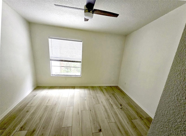 spare room featuring ceiling fan, a textured ceiling, and light hardwood / wood-style floors