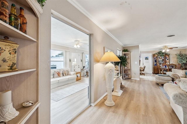 living room featuring ceiling fan, ornamental molding, and hardwood / wood-style floors