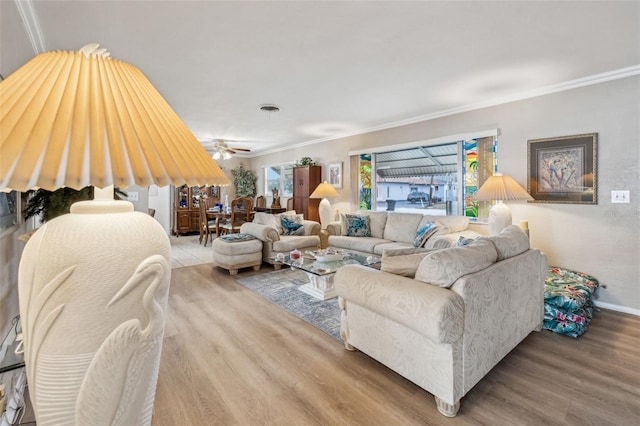 living room with ceiling fan, hardwood / wood-style floors, and ornamental molding