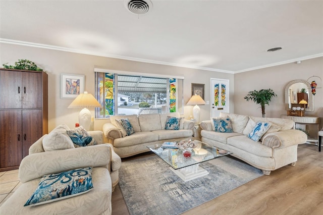 living room with light hardwood / wood-style flooring and crown molding