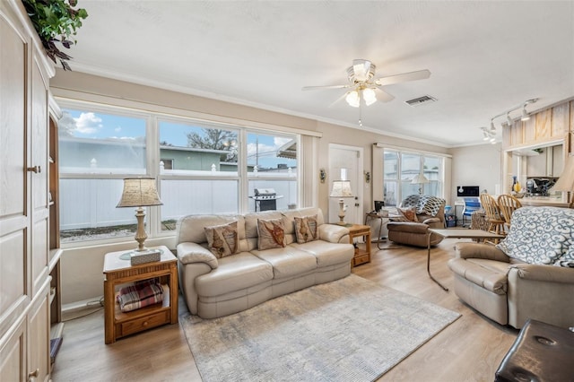 living room with ceiling fan, ornamental molding, light hardwood / wood-style flooring, and rail lighting