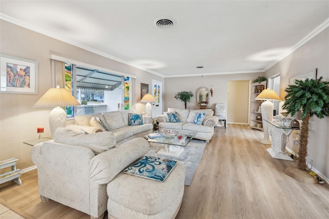 living room featuring ornamental molding and light hardwood / wood-style flooring