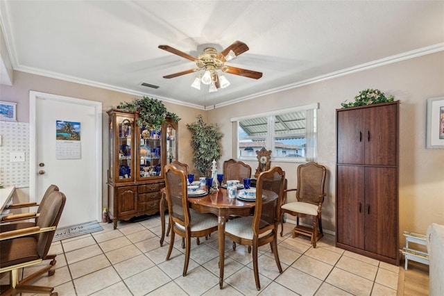 dining room featuring ceiling fan, crown molding, and light tile patterned floors