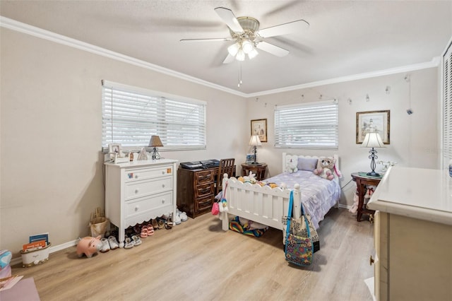 bedroom featuring multiple windows, ceiling fan, crown molding, and light hardwood / wood-style flooring