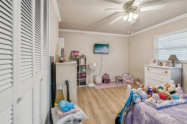 bedroom featuring ceiling fan, light wood-type flooring, and ornamental molding