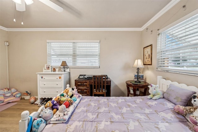 unfurnished bedroom featuring ceiling fan, light hardwood / wood-style flooring, ornamental molding, and multiple windows