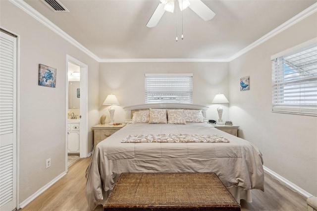 bedroom featuring ensuite bathroom, light wood-type flooring, ceiling fan, and ornamental molding