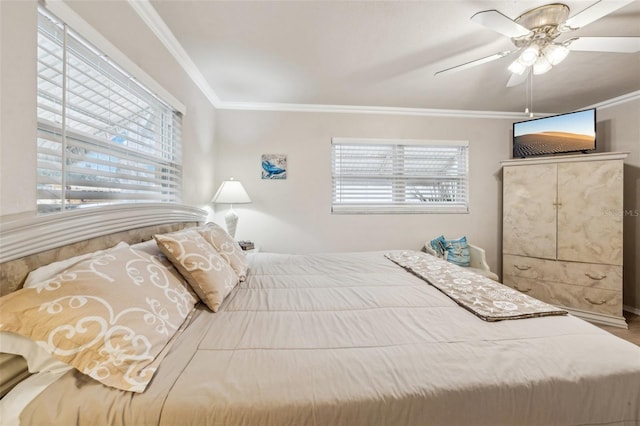 bedroom with ceiling fan, ornamental molding, and multiple windows