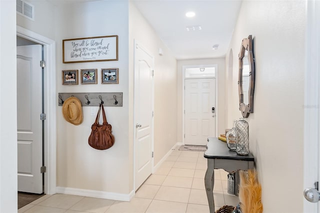 doorway with light tile patterned floors