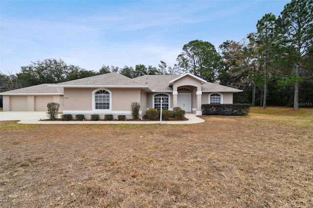 single story home with a front lawn and a garage