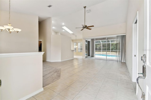 tiled empty room with ceiling fan with notable chandelier and high vaulted ceiling