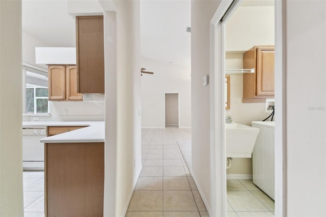 hall with light tile patterned floors and washer / clothes dryer