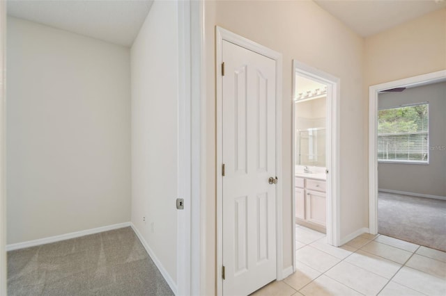 corridor featuring light tile patterned floors