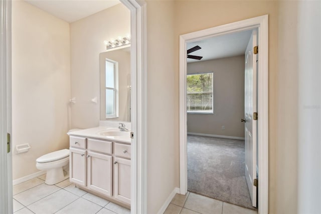 bathroom with toilet, tile patterned flooring, and vanity