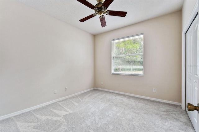 unfurnished bedroom with ceiling fan, a closet, and light carpet