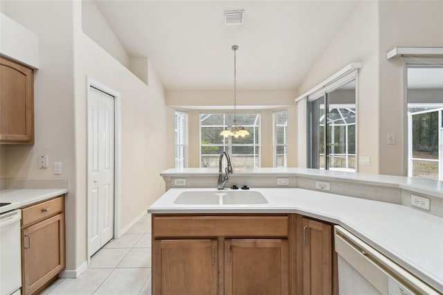 kitchen featuring a notable chandelier, decorative light fixtures, dishwasher, a wealth of natural light, and sink