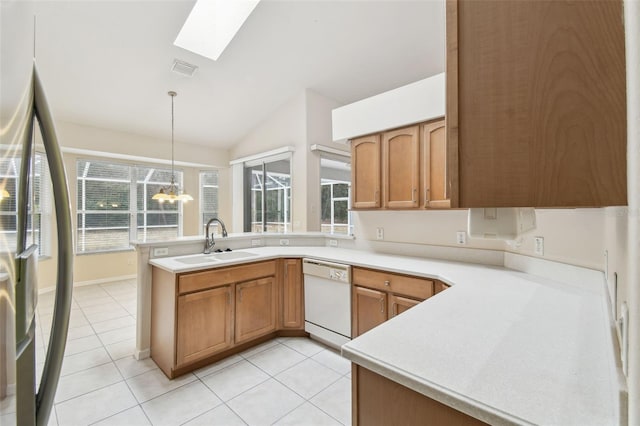 kitchen featuring decorative light fixtures, dishwasher, kitchen peninsula, sink, and plenty of natural light