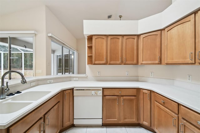 kitchen with sink, white dishwasher, and light tile patterned flooring