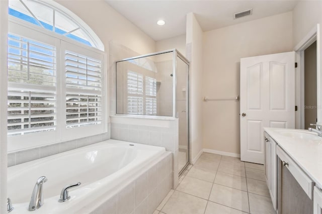 bathroom featuring independent shower and bath, tile patterned flooring, and vanity