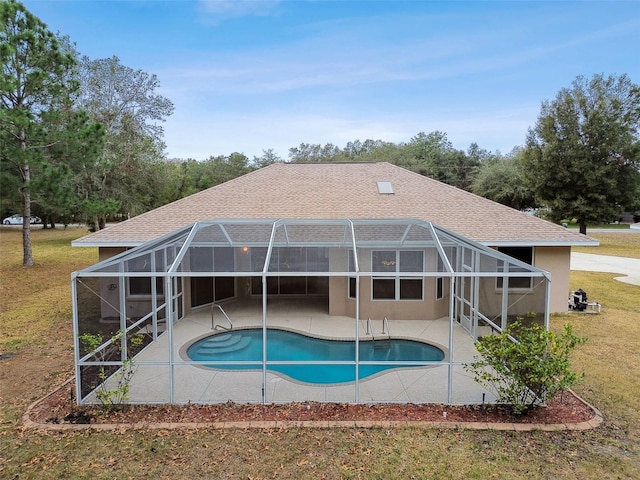 view of pool featuring a lanai, a lawn, and a patio