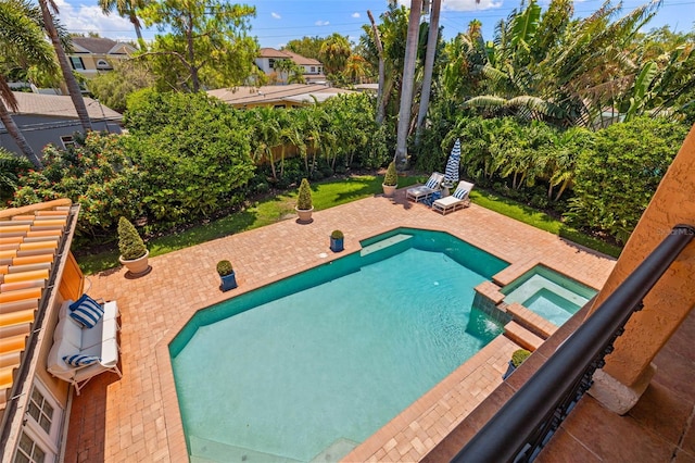 view of pool featuring a pool with connected hot tub and a patio