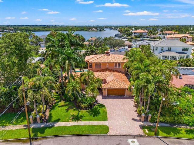 drone / aerial view with a water view and a residential view