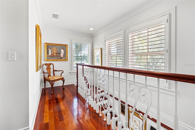 hall with ornamental molding, baseboards, visible vents, and dark wood-type flooring