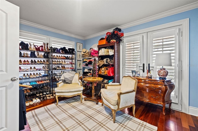 living area featuring ornamental molding and wood finished floors