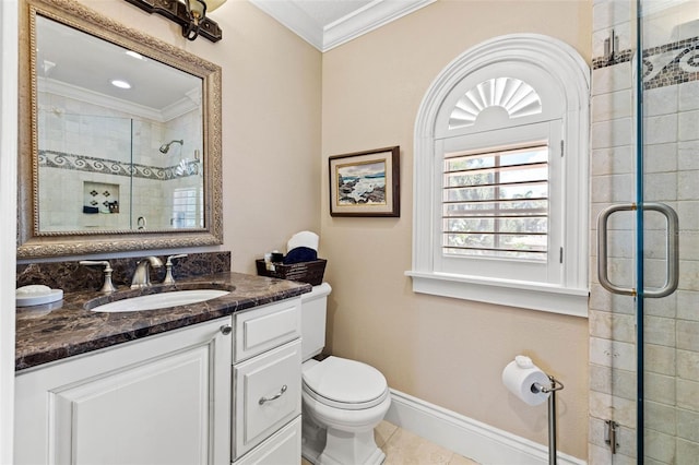 bathroom with tile patterned flooring, toilet, vanity, ornamental molding, and a tile shower