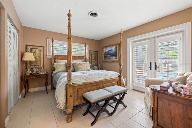 bedroom with access to exterior, light tile patterned floors, visible vents, and french doors